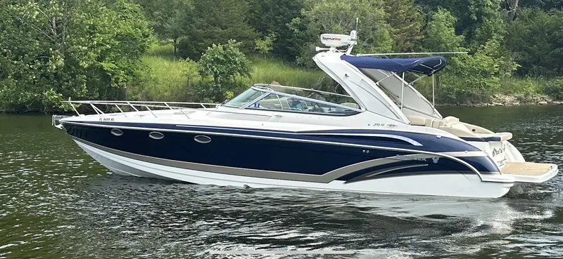 Slide: The Image of 2018 Formula 370 Super Sport boat cruising on a serene lake with lush greenery. - 34