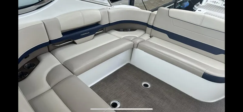 Slide: The Image of 2018 Formula 370 Super Sport boat interior with beige and navy seating. - 9