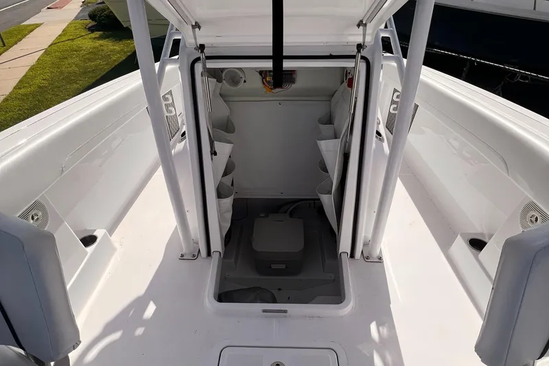 Slide: The Image of 2023 Wellcraft 222 Fisherman boat interior with storage compartments and seating. - 11
