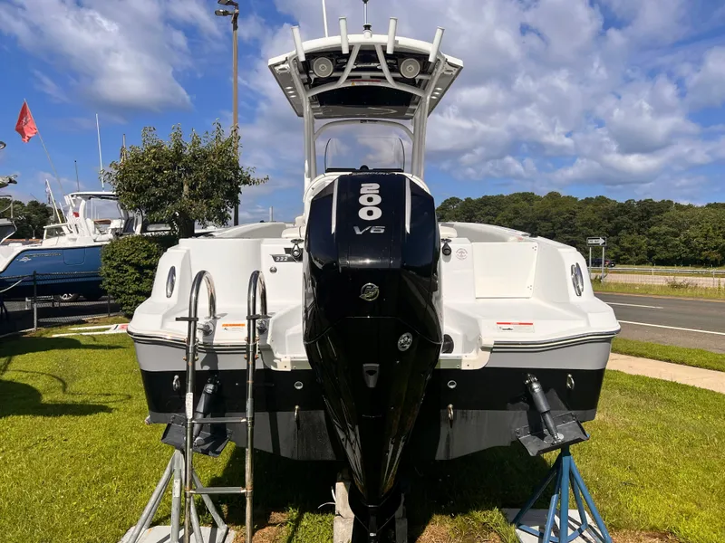 Slide: The Image of 2023 Wellcraft 222 Fisherman boat with 200 V6 engine, displayed outdoors. - 4