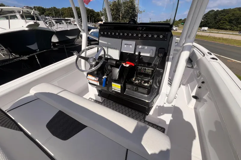 Slide: The Image of 2023 Wellcraft 222 Fisherman boat cockpit with steering wheel and control panel. - 7