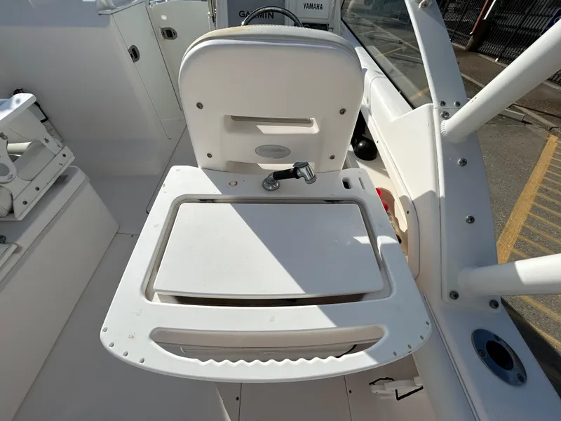 Slide: The Image of 2013 Everglades 230 Dual Console boat interior with seating and storage area. - 10