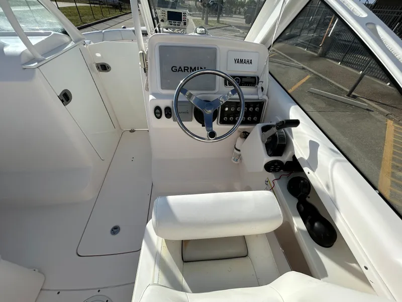 Slide: The Image of 2013 Everglades 230 Dual Console boat interior with Garmin and Yamaha controls. - 11
