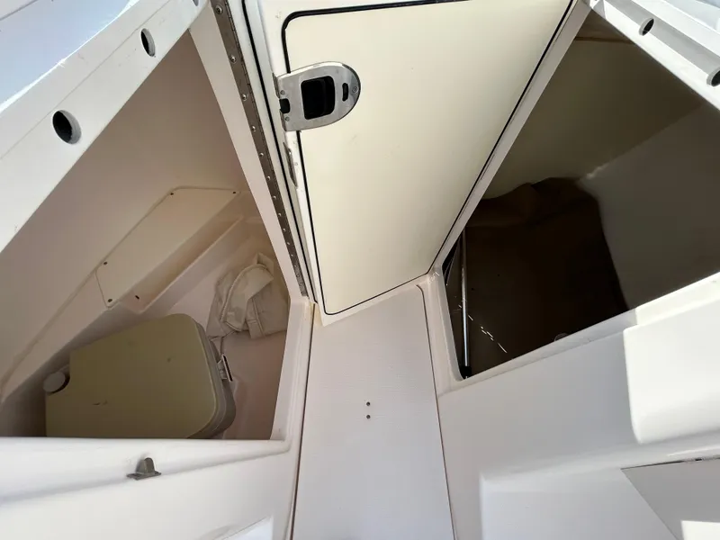 Slide: The Image of Interior view of 2013 Everglades 230 Dual Console boat storage compartments. - 13