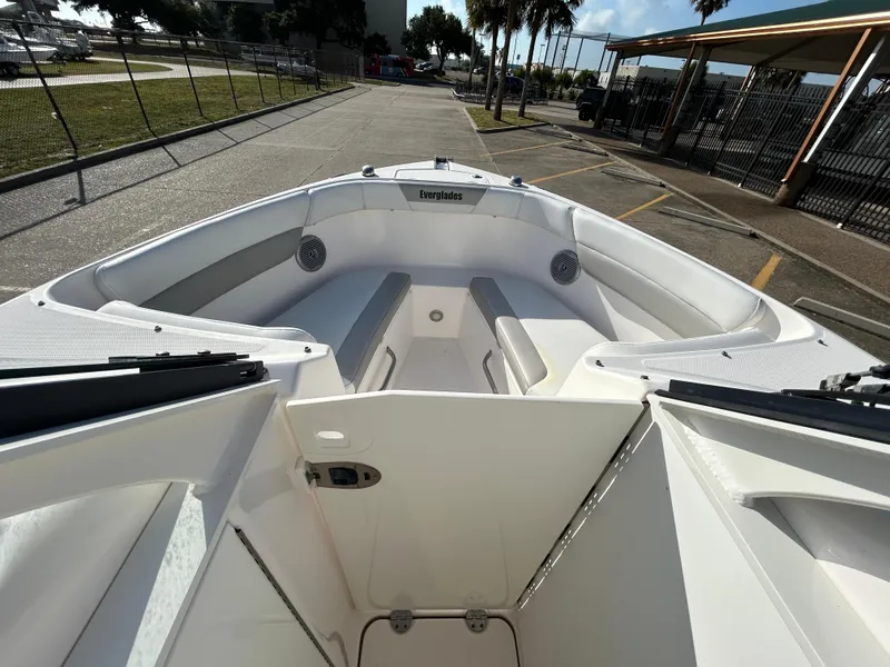 Slide: The Image of 2013 Everglades 230 Dual Console boat interior with seating and open deck view. - 14