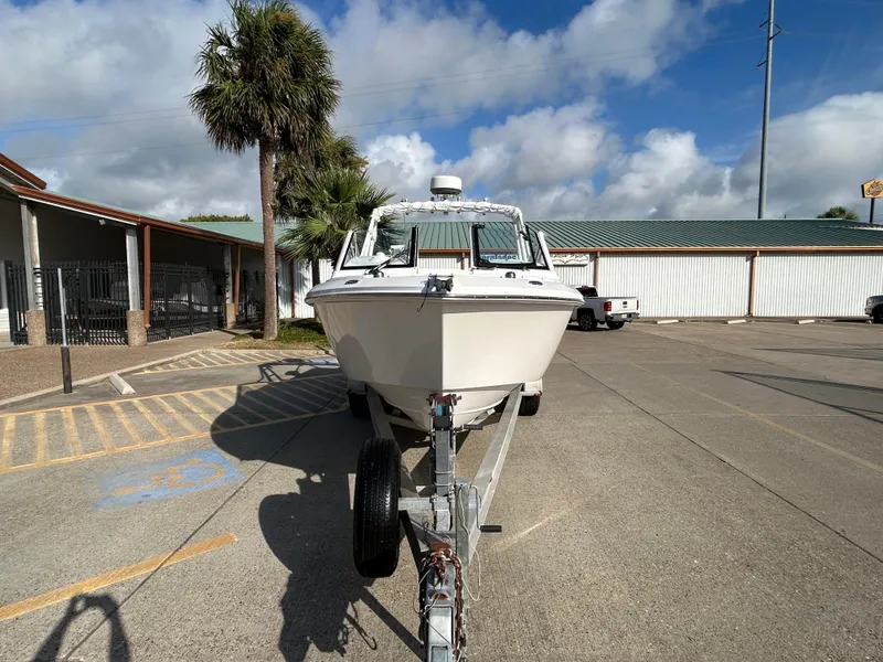 Slide: The Image of 2013 Everglades 230 Dual Console boat on trailer in parking lot, sunny day. - 3
