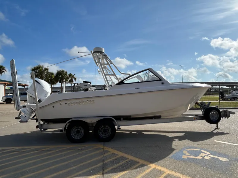 Slide: The Image of 2013 Everglades 230 Dual Console boat on trailer under clear blue sky. - 4