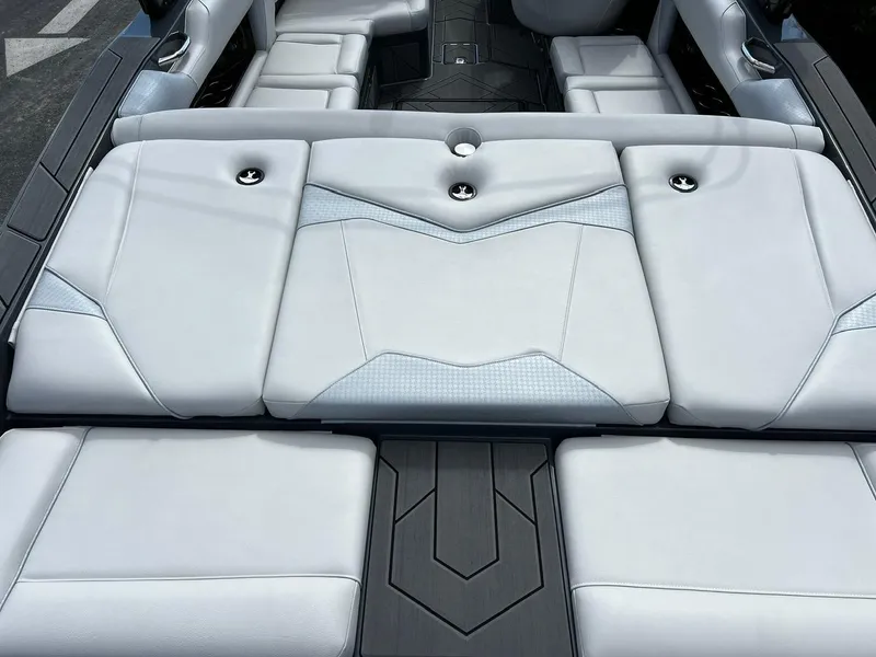 Slide: The Image of 2024 Supreme S220 boat interior with sleek white seating and modern design. - 13