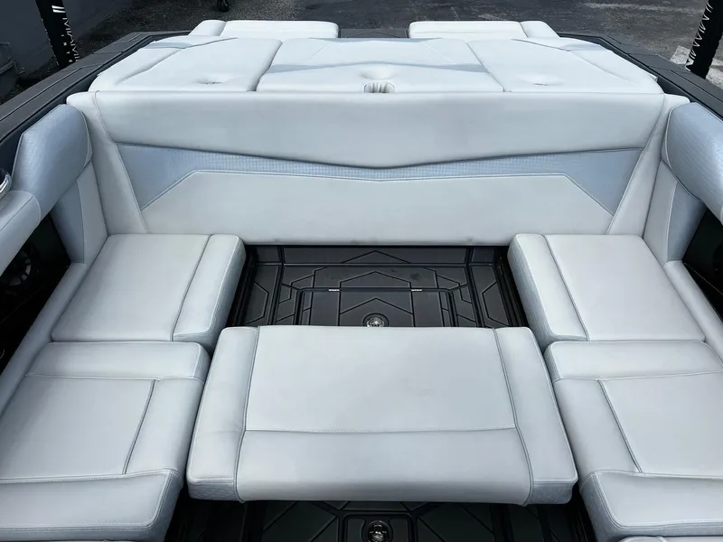 Slide: The Image of 2024 Supreme S220 boat interior with luxurious white seating and modern design. - 18