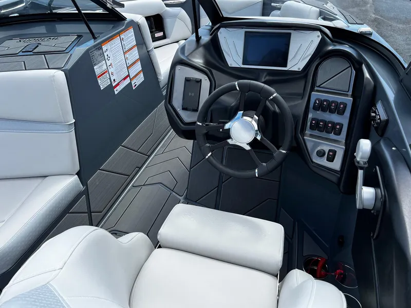 Slide: The Image of 2024 Supreme S220 boat interior with modern dashboard and steering wheel. - 19