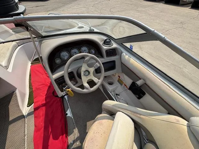 Slide: The Image of 2002 Four Winns 190 Horizon boat cockpit with steering wheel and dashboard controls. - 11