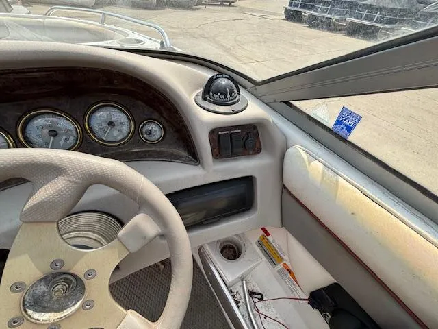Slide: The Image of 2002 Four Winns 190 Horizon boat dashboard with steering wheel and gauges. - 12