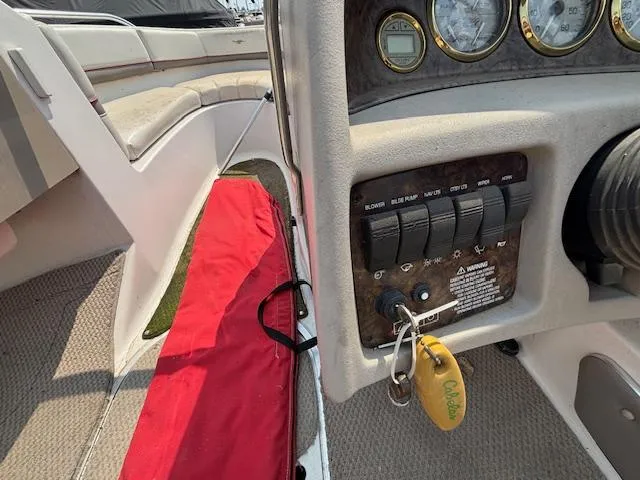 Slide: The Image of 2002 Four Winns 190 Horizon boat dashboard with key ignition and control panel. - 15