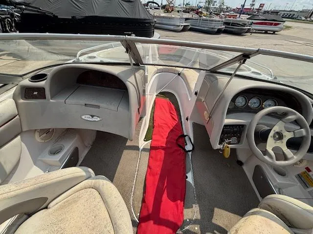 Slide: The Image of 2002 Four Winns 190 Horizon boat interior with steering wheel, dashboard, and seating. - 16