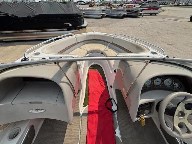 Slide: The Image of 2002 Four Winns 190 Horizon boat interior with red carpet and dashboard view. - 17