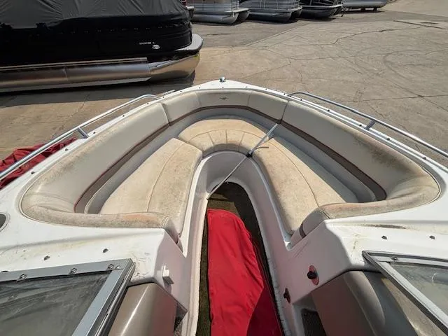 Slide: The Image of 2002 Four Winns 190 Horizon boat interior with beige seating and red cover. - 18