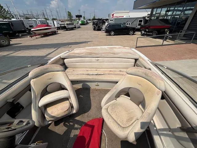 Slide: The Image of 2002 Four Winns 190 Horizon boat interior with worn seats, parked in a marina. - 20