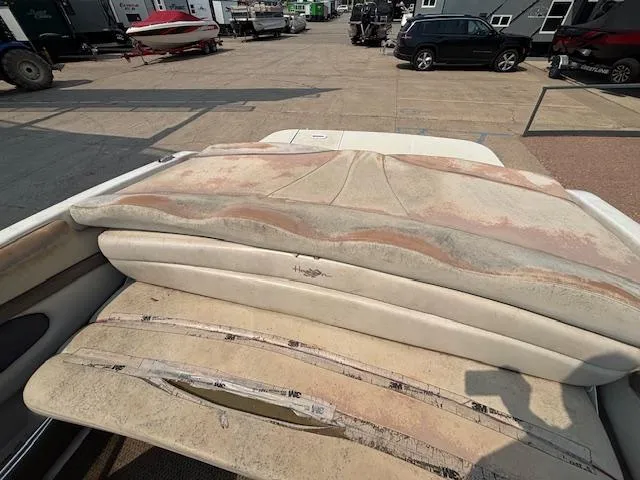 Slide: The Image of 2002 Four Winns 190 Horizon boat with worn upholstery in a marina setting. - 22