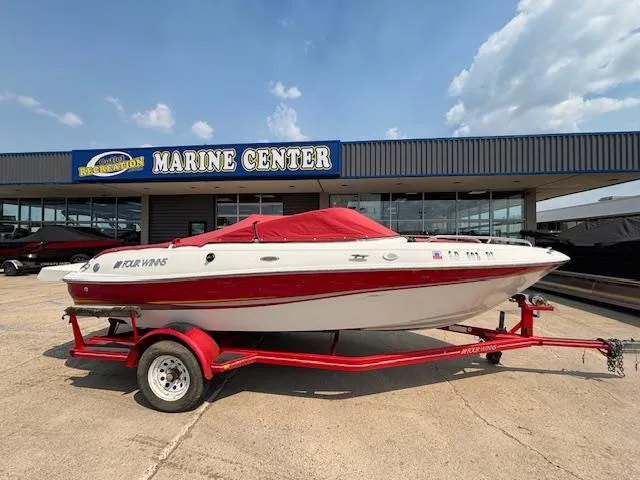 Slide: The Image of 2002 Four Winns 190 Horizon boat on red trailer at marine center. - 5