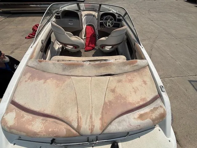 Slide: The Image of 2002 Four Winns 190 Horizon boat with worn upholstery and visible seating arrangement. - 6