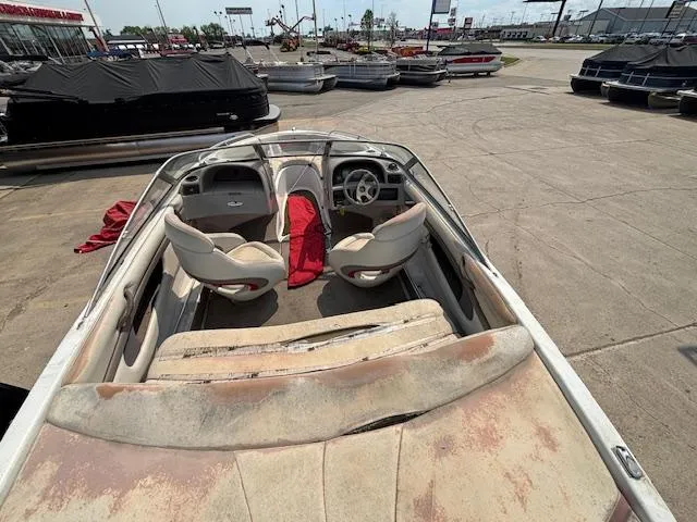 Slide: The Image of 2002 Four Winns 190 Horizon boat with worn interior, parked in a marina. - 7