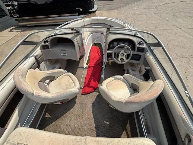 Slide: The Image of 2002 Four Winns 190 Horizon boat interior with seating and steering wheel. - 8