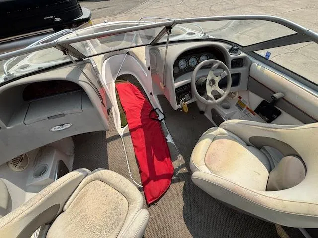 Slide: The Image of 2002 Four Winns 190 Horizon boat interior with steering wheel and seating. - 9