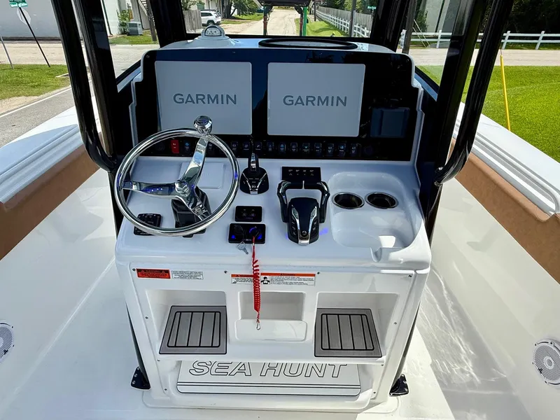 Slide: The Image of 2023 Sea Hunt Gamefish 27 helm with dual Garmin displays and modern controls. - 11