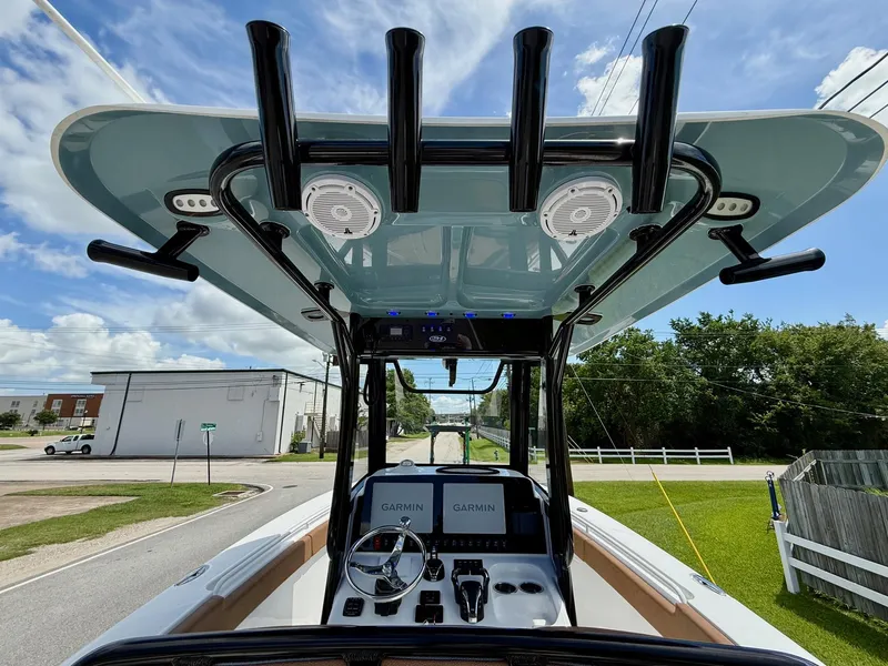Slide: The Image of 2023 Sea Hunt Gamefish 27 boat with forward seating, featuring Garmin electronics and rod holders. - 12