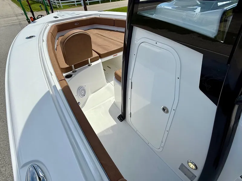 Slide: The Image of 2023 Sea Hunt Gamefish 27 Forward Seating boat with brown cushioned seats and white deck. - 13