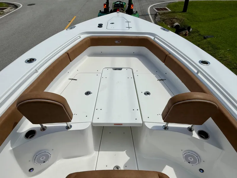 Slide: The Image of 2023 Sea Hunt Gamefish 27 Forward Seating with brown cushions and spacious deck layout. - 16