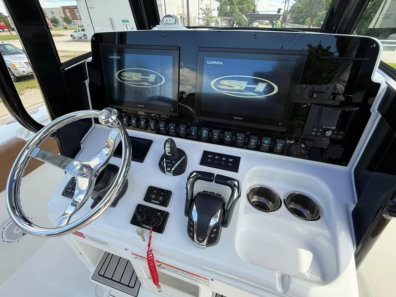 Slide: The Image of 2023 Sea Hunt Gamefish 27 dashboard with Garmin displays and modern controls. - 18