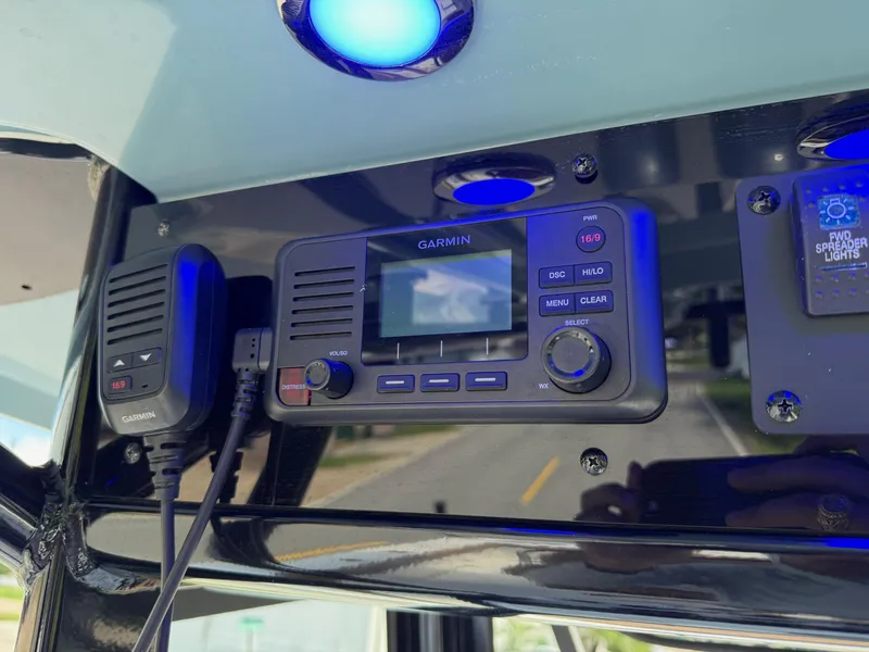 Slide: The Image of Garmin marine radio on 2023 Sea Hunt Gamefish 27, featuring blue LED lighting. - 19