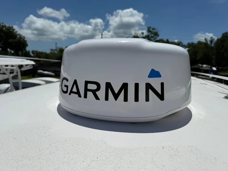 Slide: The Image of Garmin device on 2023 Sea Hunt Gamefish 27 boat under clear blue sky. - 22