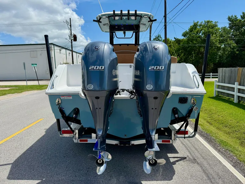 Slide: The Image of 2023 Sea Hunt Gamefish 27 with twin Yamaha 200 engines, parked on a sunny street. - 3
