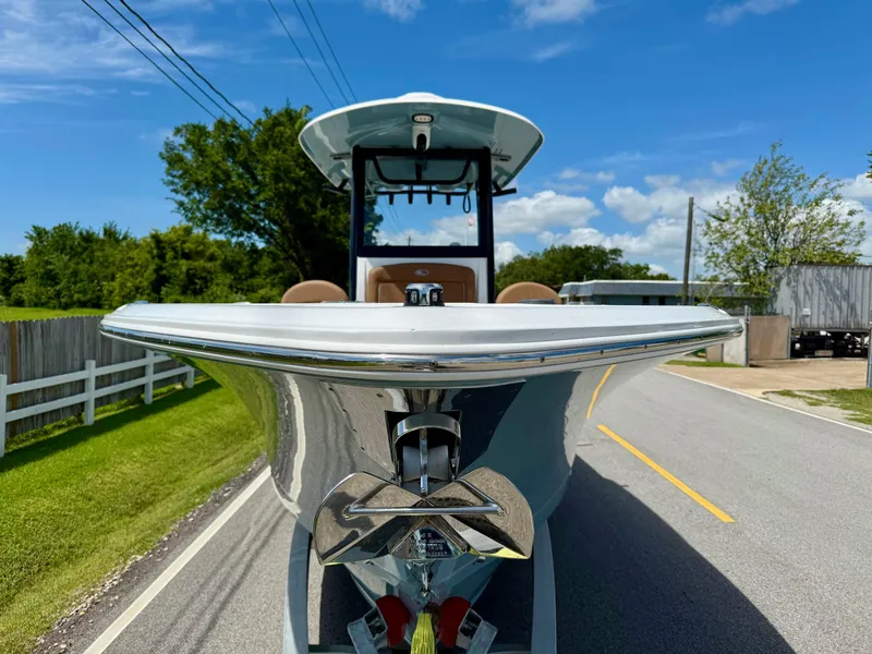 Slide: The Image of 2023 Sea Hunt Gamefish 27 boat on road, showcasing sleek design and forward seating. - 6