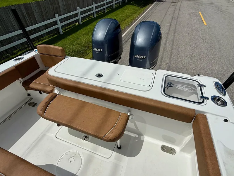 Slide: The Image of 2023 Sea Hunt Gamefish 27 boat with dual Yamaha 200 engines and brown seating. - 7