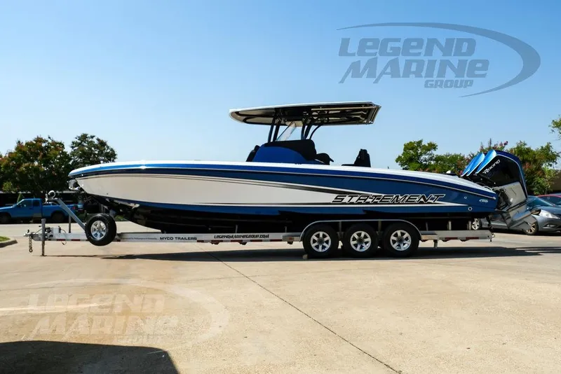 Slide: The Image of 2023 Statement 350 Open boat on trailer, displayed outdoors at Legend Marine Group. - 11