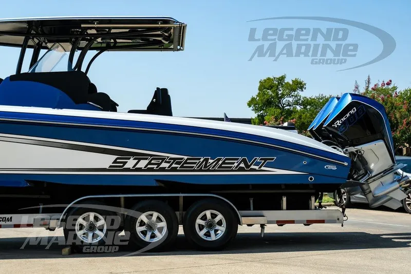 Slide: The Image of 2023 Statement 350 Open boat on trailer, featuring sleek blue design and powerful engine. - 13