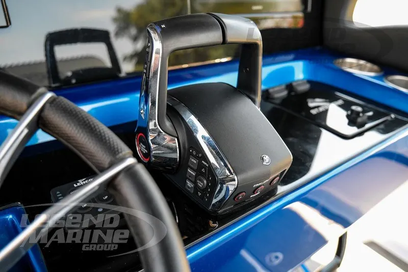 Slide: The Image of Control panel of 2023 Statement 350 Open boat, featuring sleek throttle and steering wheel. - 26