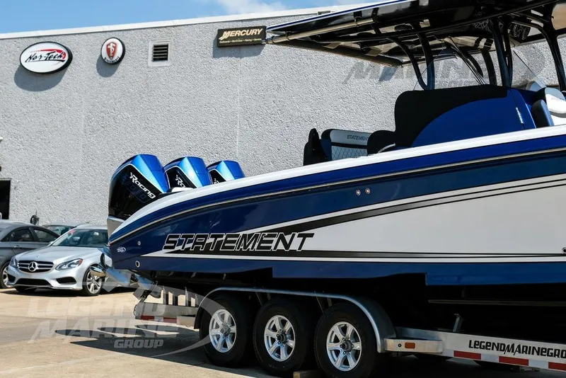 Slide: The Image of 2023 Statement 350 Open boat with triple Mercury engines on a trailer. - 3
