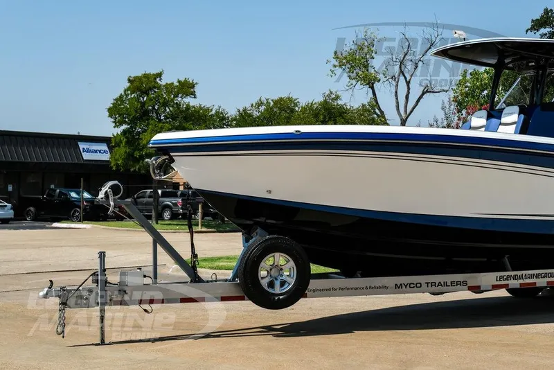 Slide: The Image of 2023 Statement 350 Open boat on trailer in parking lot. - 4