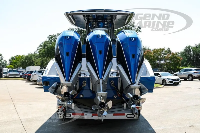 Slide: The Image of 2023 Statement 350 Open boat with triple outboard engines, parked outdoors. - 5