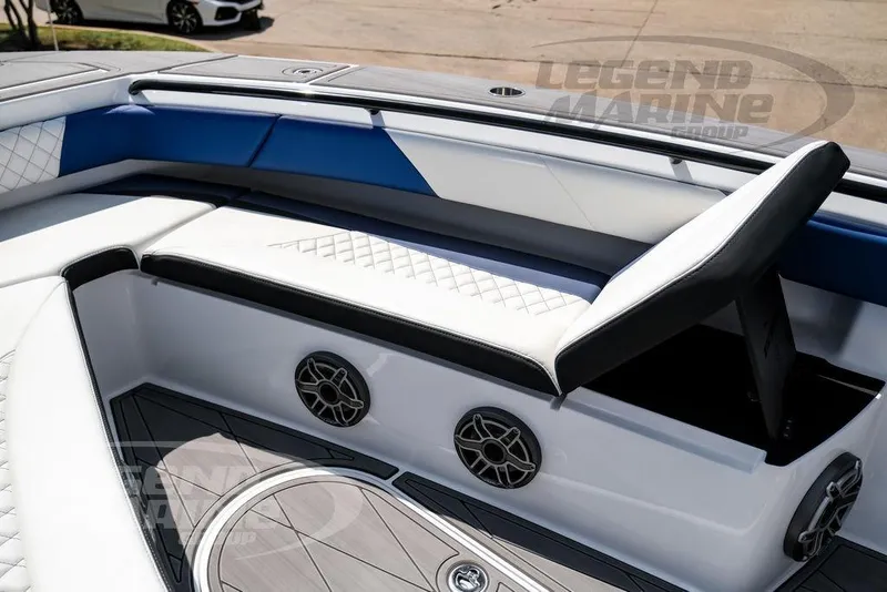 Slide: The Image of 2023 Statement 350 Open boat interior with white and blue seating, speakers, and deck. - 53