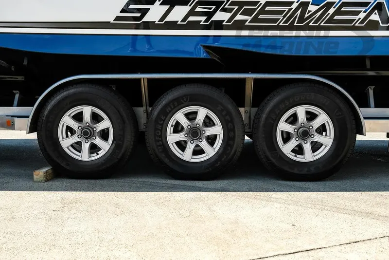 Slide: The Image of Trailer wheels of 2023 Statement 350 Open boat on pavement. - 58