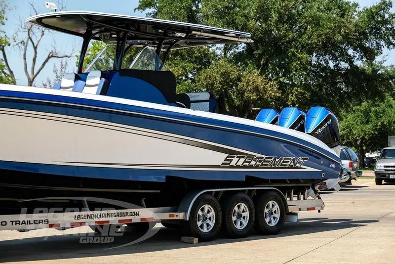Slide: The Image of 2023 Statement 350 Open boat on trailer, featuring sleek design and powerful engines. - 6