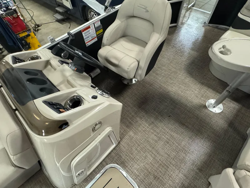 Slide: The Image of 2019 Bennington S21 boat interior with captain's chair and control panel. - 12