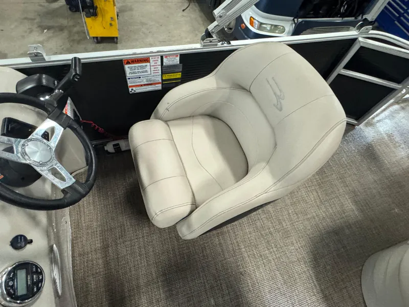 Slide: The Image of Captain's chair and steering wheel of a 2019 Bennington S21 boat. - 15