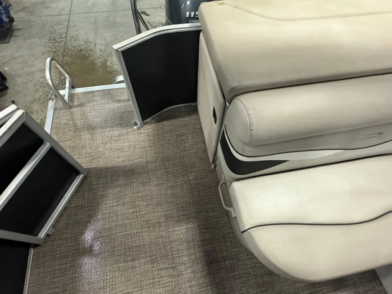 Slide: The Image of 2019 Bennington S21 boat interior with beige seating and textured flooring. - 17