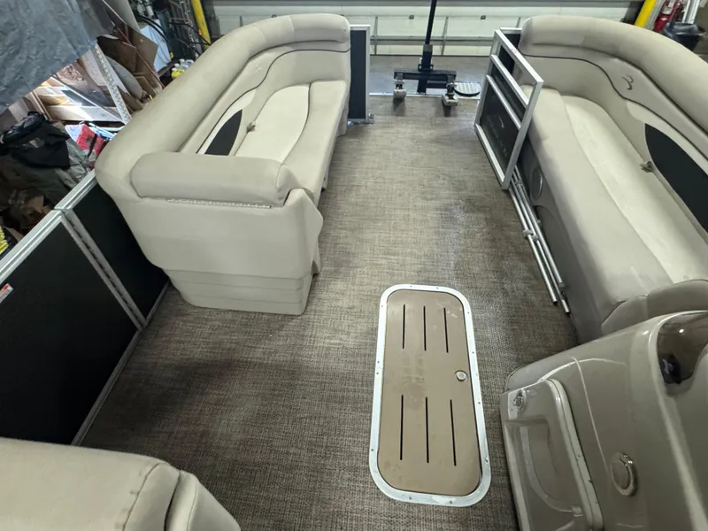 Slide: The Image of 2019 Bennington S21 pontoon boat interior with beige seating and carpeted floor. - 20